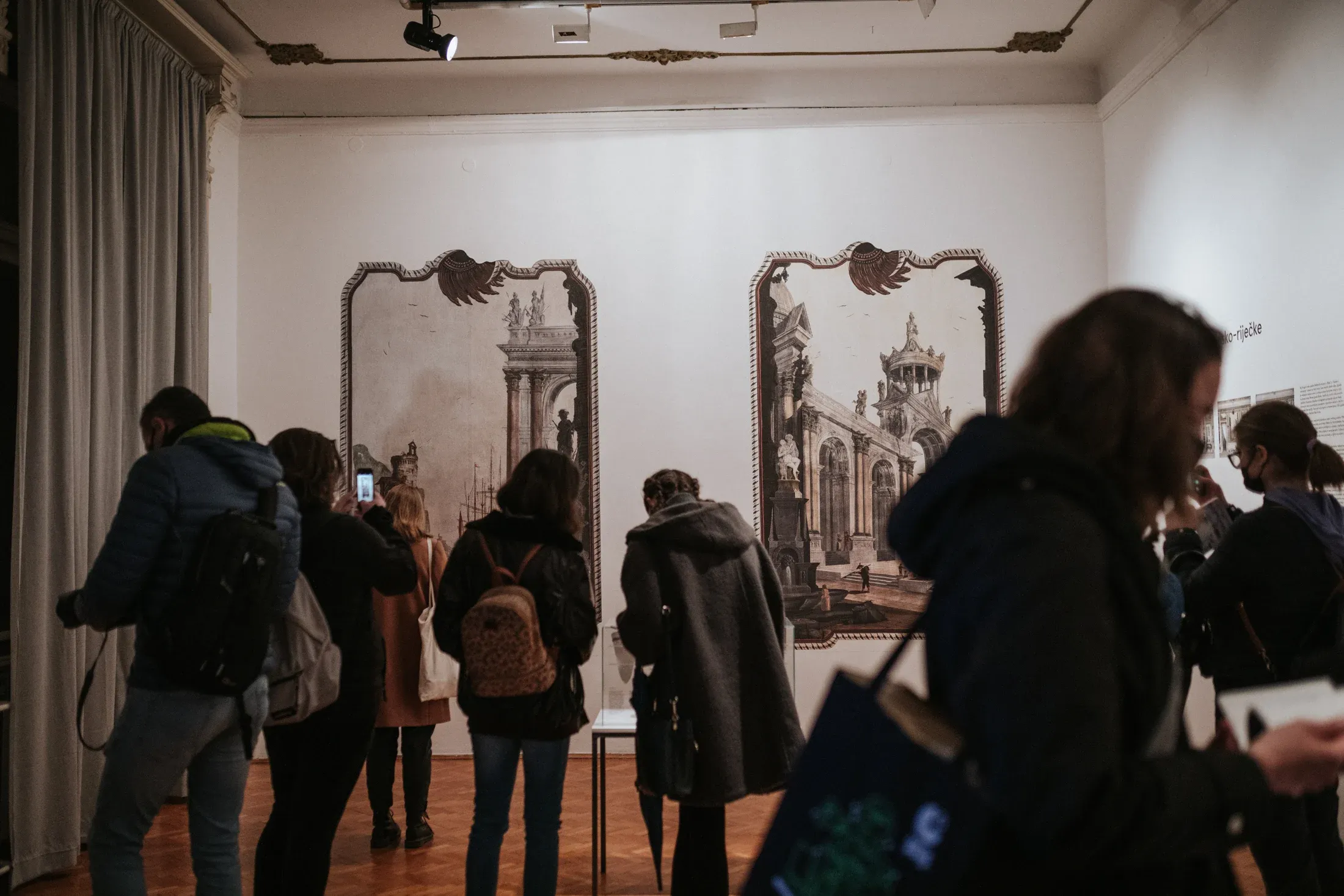 Visitors in front of two prints of the vedute