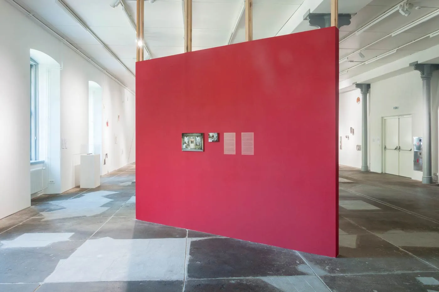 Exhibition view of the work on the red wall