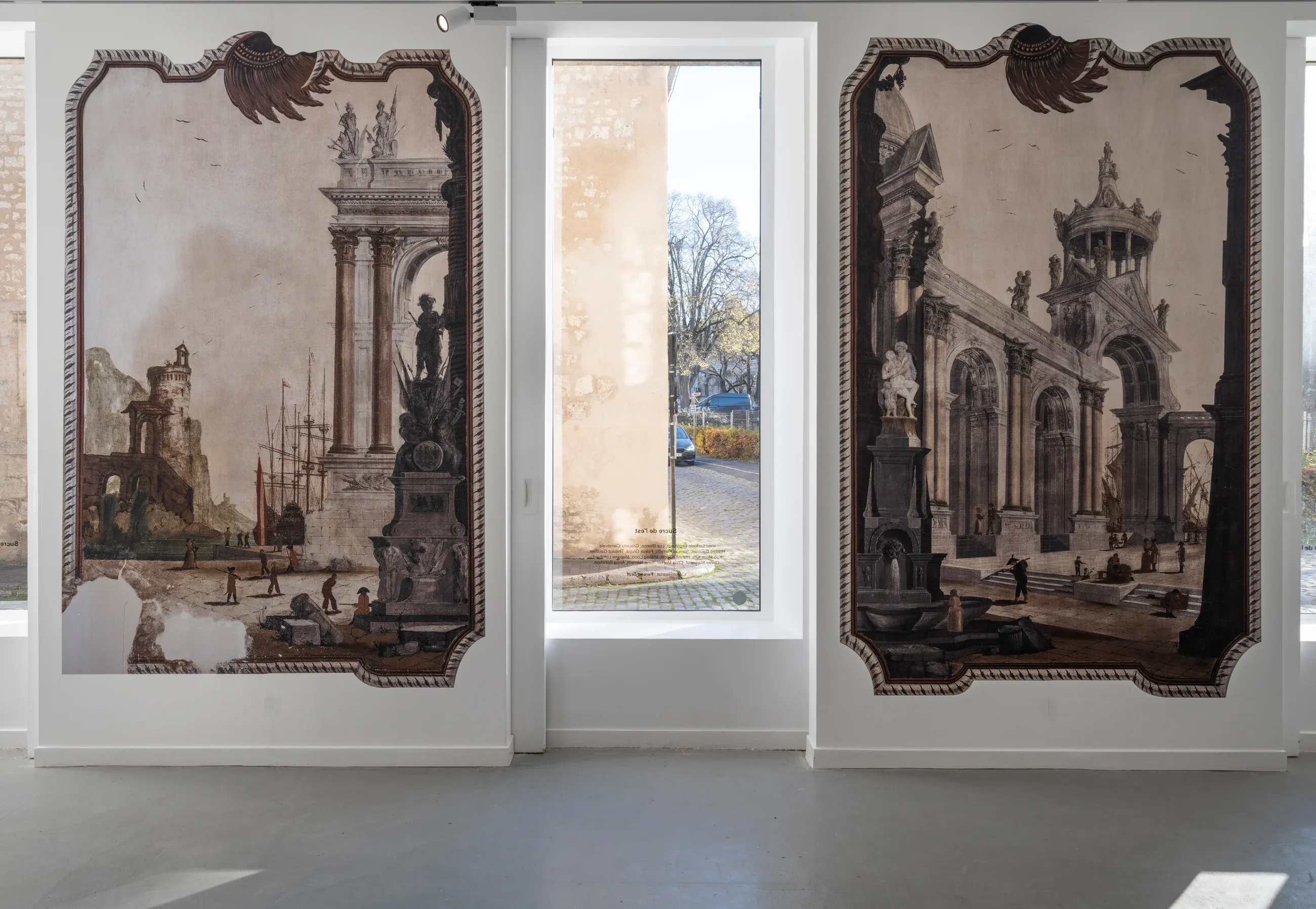 Two large prints of the vedute on either side of a window